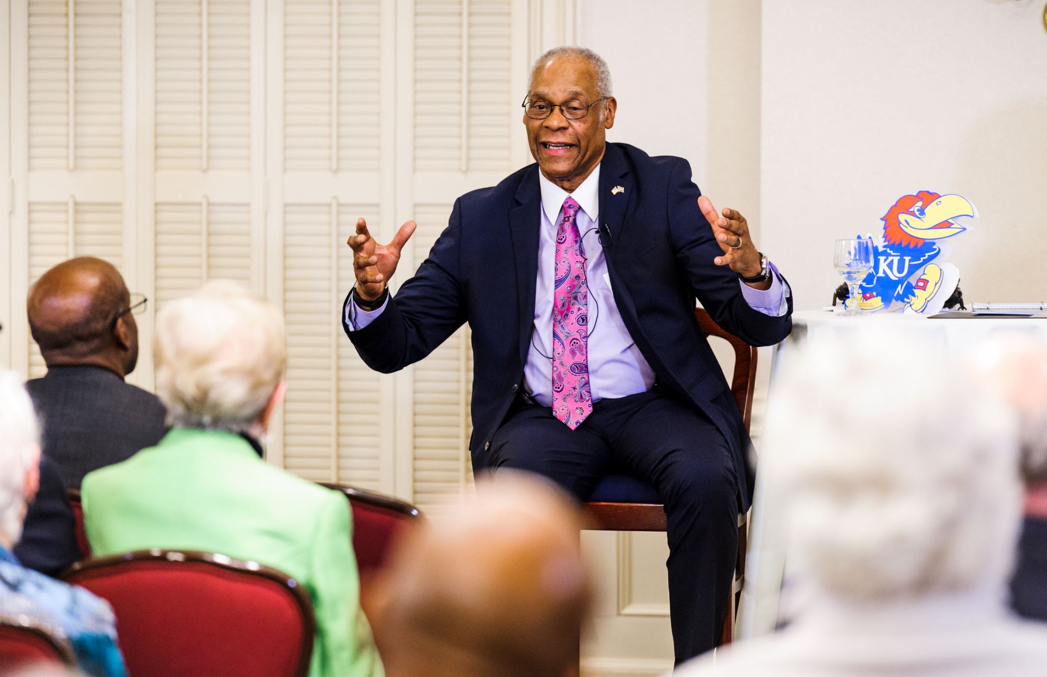 Delano Lewis speaks to a room of people