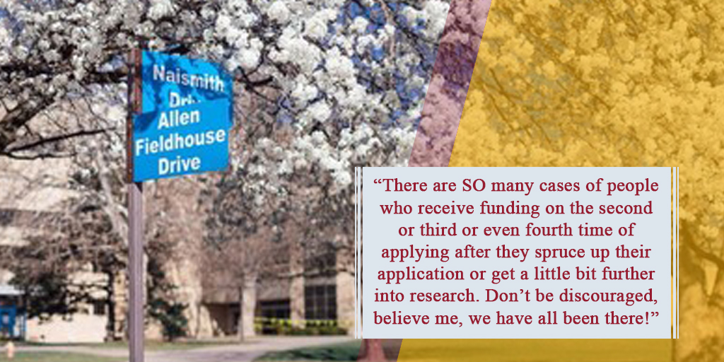 A street sign at the intersection of Naismith Drive and Allen Fieldhouse Drive with the quote, 'There are SO many cases of people who receive funding on the second or third or even fourth time of applying after they spruce up their application or get a little bit further into research.  Don’t be discouraged, believe me, we have all been there!'