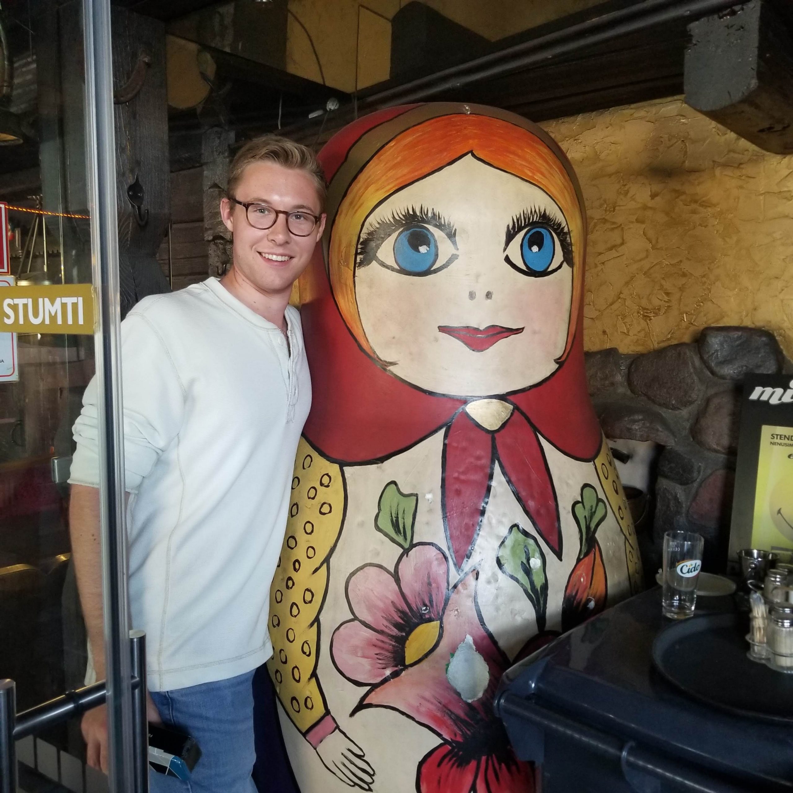 Mason next to a life-sized Russian doll