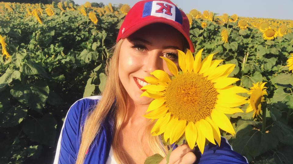 Tyan Fairbank holding a sunflower