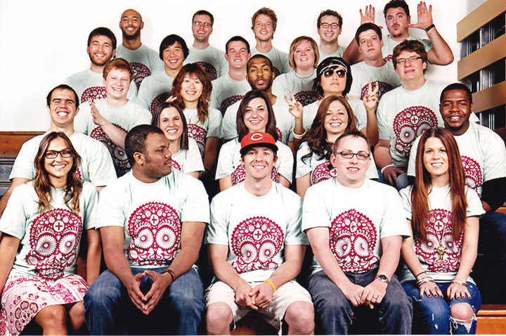 kris sitting with a group of students all with matching shirts