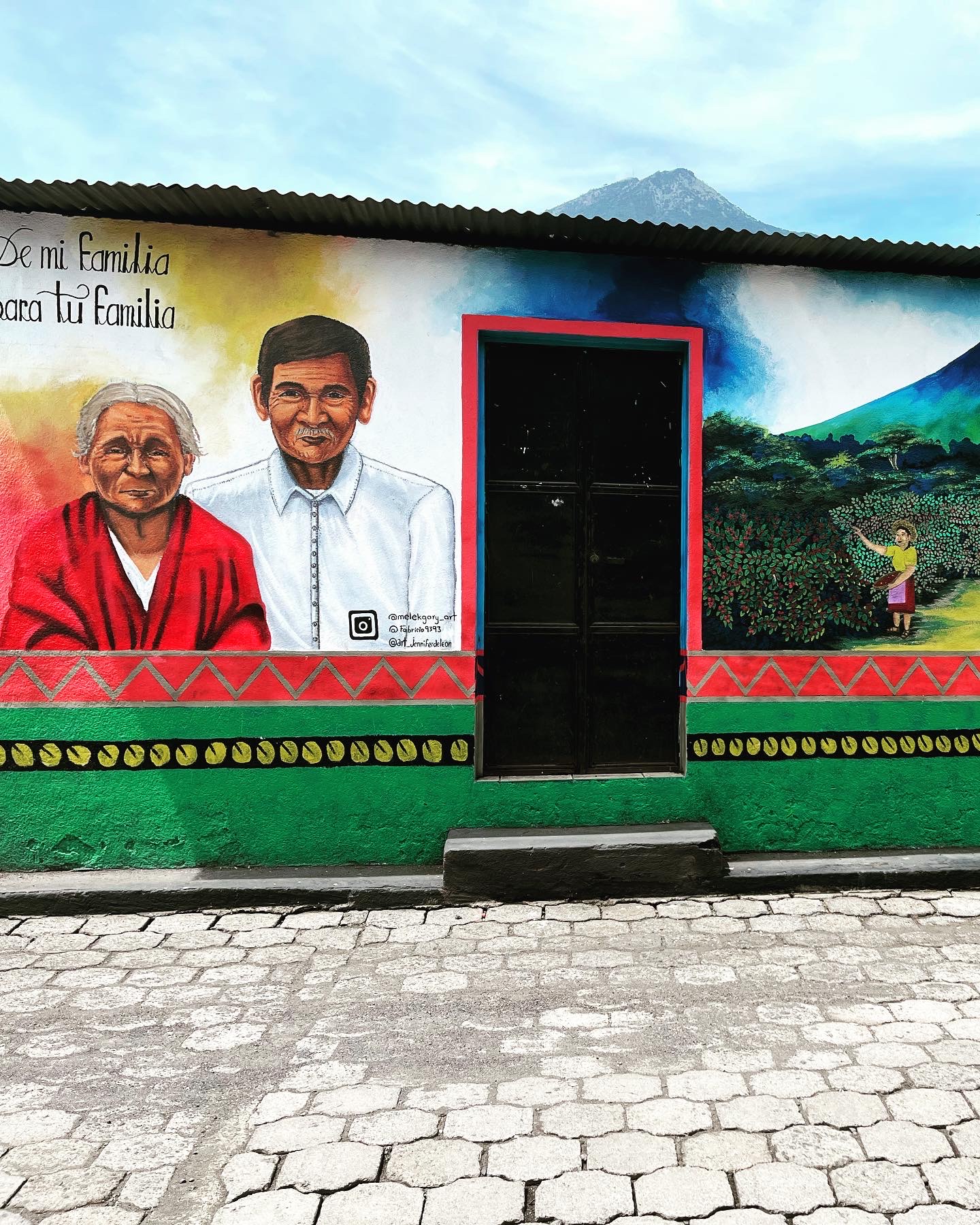 A wall with a door and a mural on it