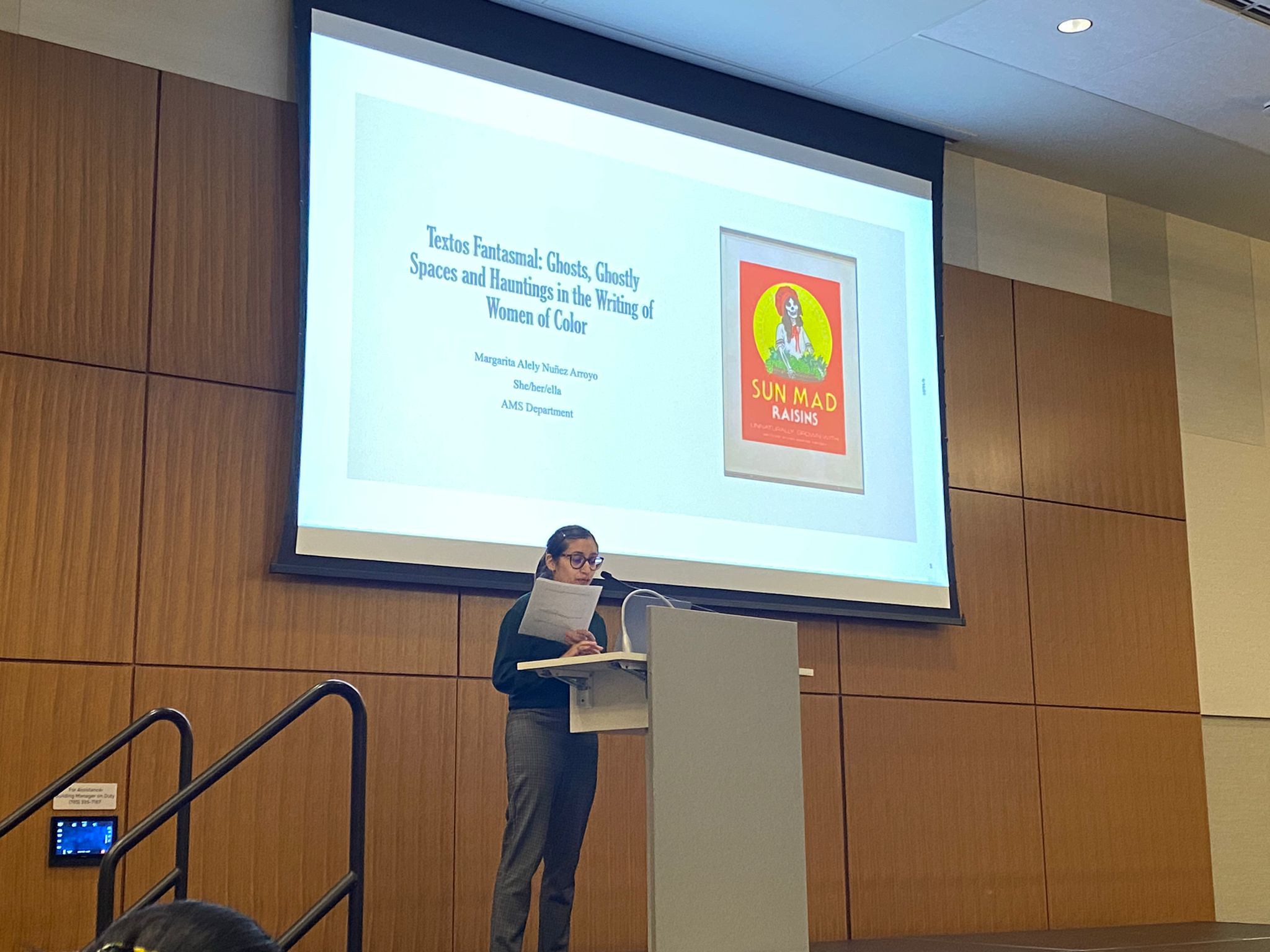 Margarita giving a presentation at a lectern