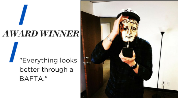 Image shows Barry holding a gold mask award, a BAFTA, in front of his face. Text reads "Award Winner. Everything looks better through a BAFTA."