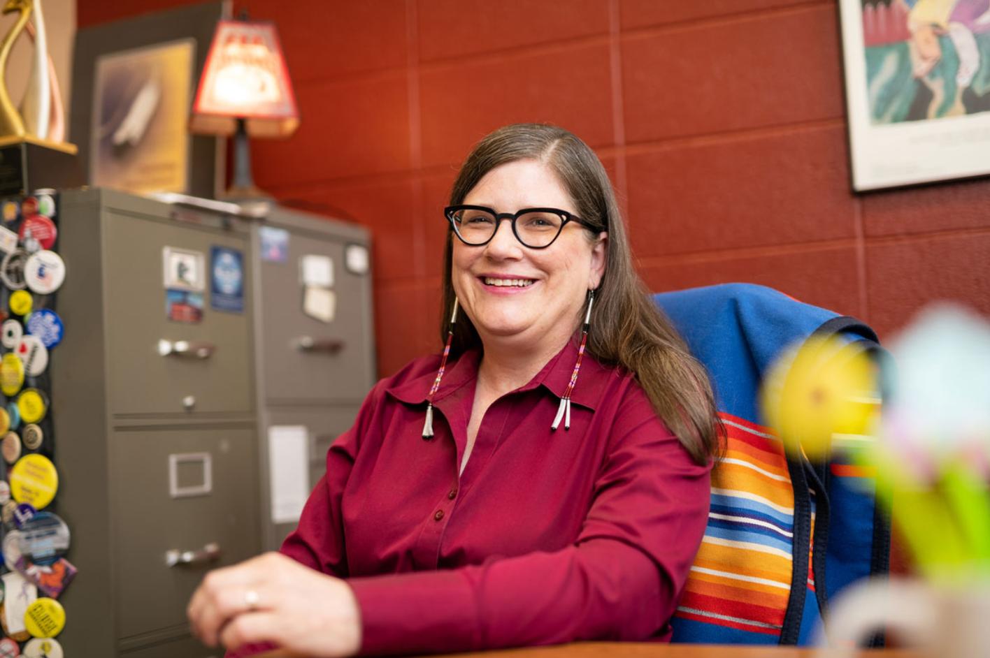 Sarah Deer smiling in her office