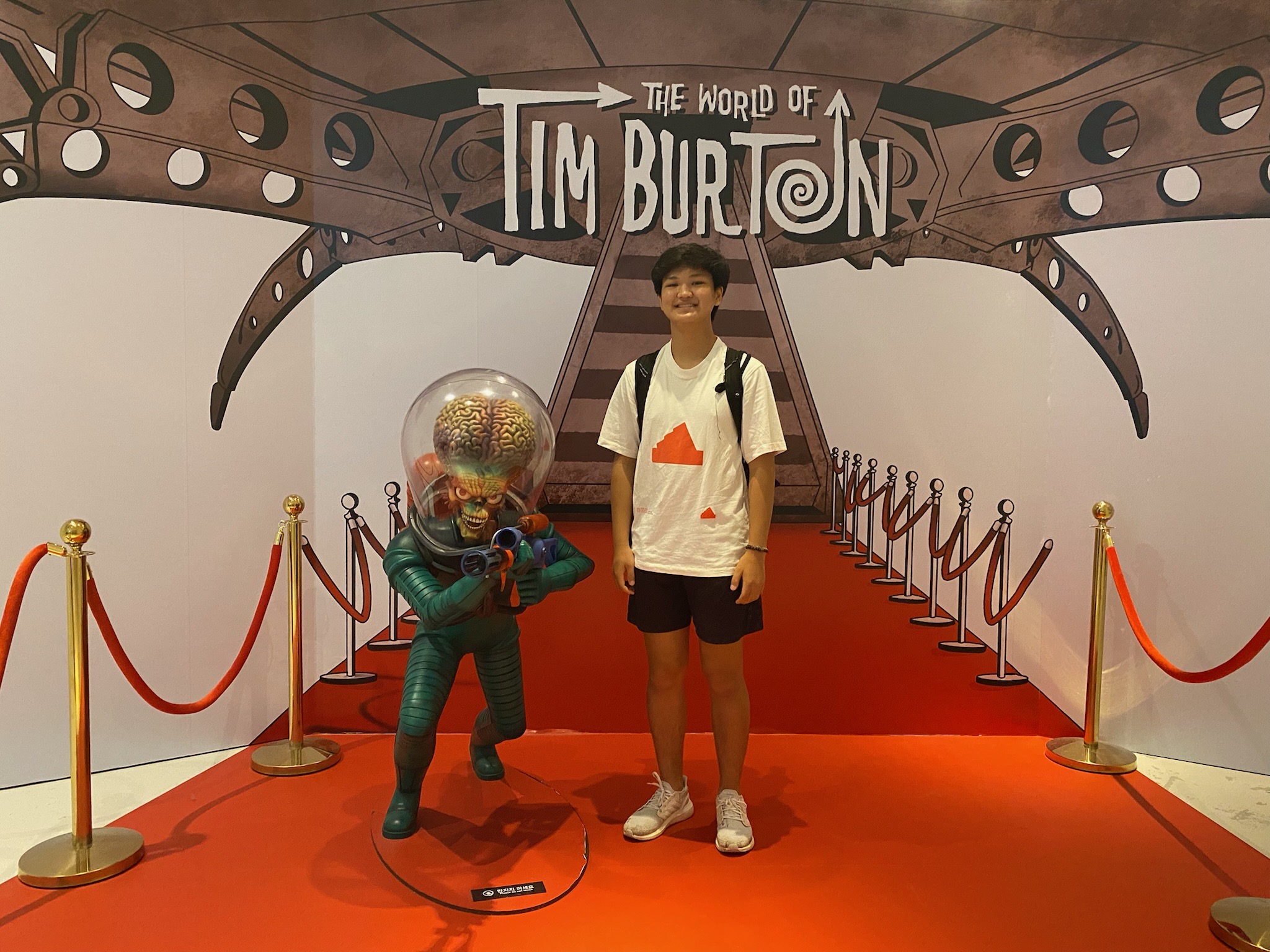 Jiyoon Park at the 'World of Tim Burton' beside a Mars Attacks figure