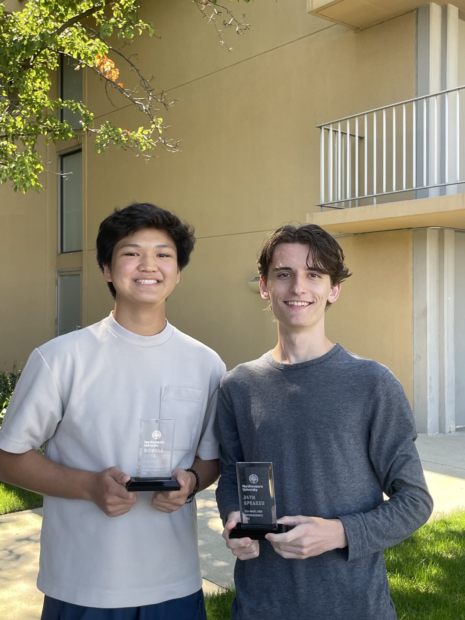 two people posing with awards they won