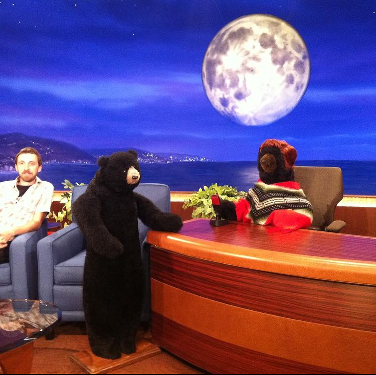 Two bears in costume in a late night talk show