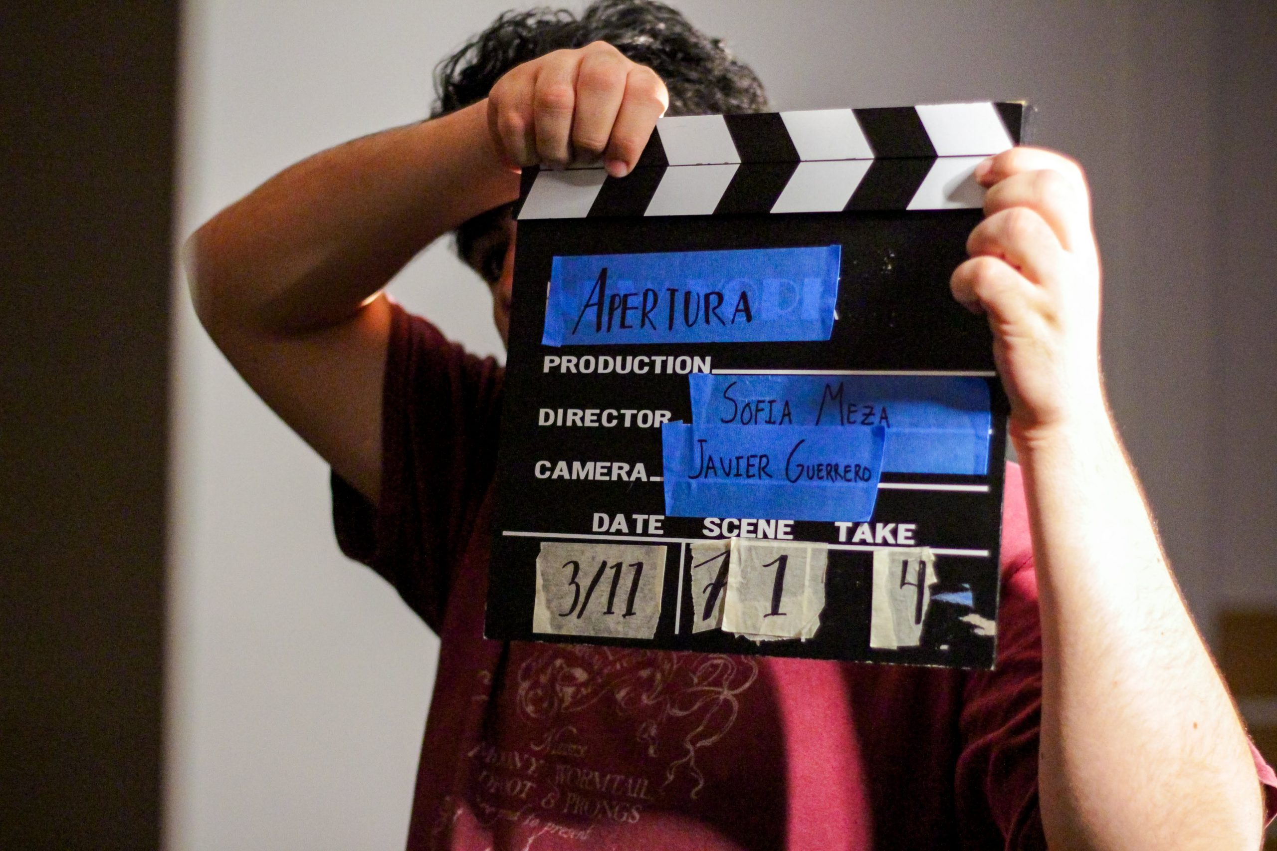 A person holding a clapperboard