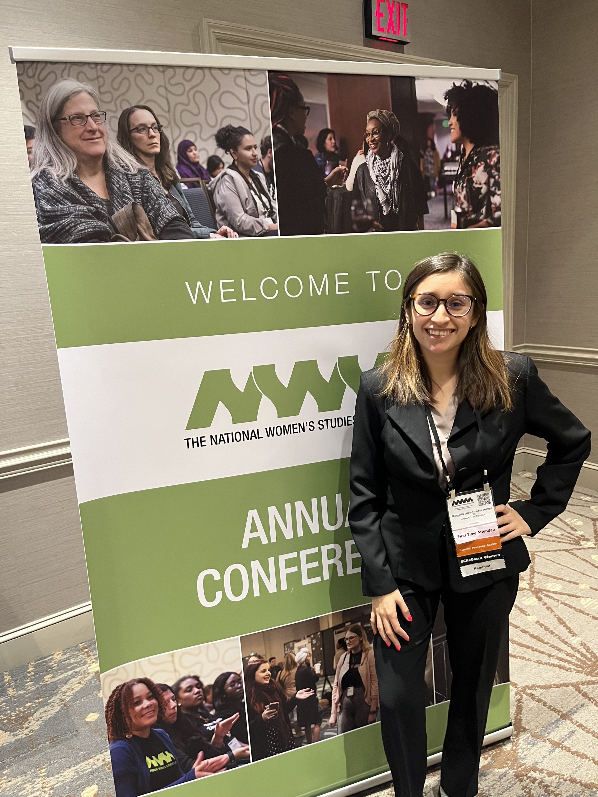 Margarita in front of a National Women's Studies Annual Conference poster