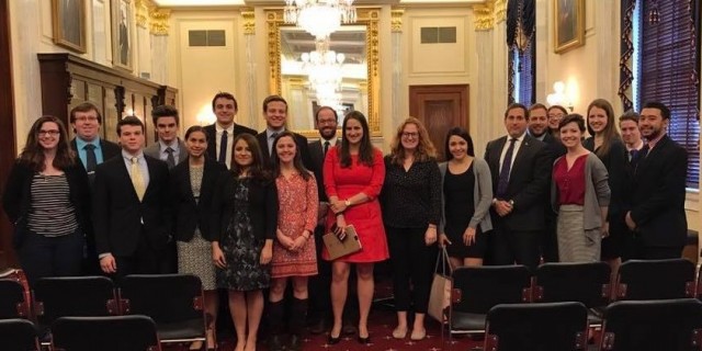 A large group of people dressed formally gathered for a group photo