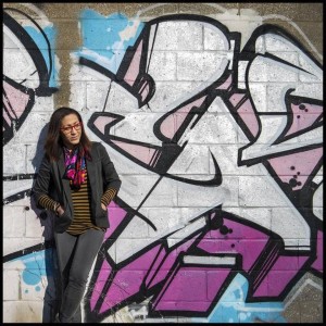 Nicole Hodges Persley in front of graffiti style wall art