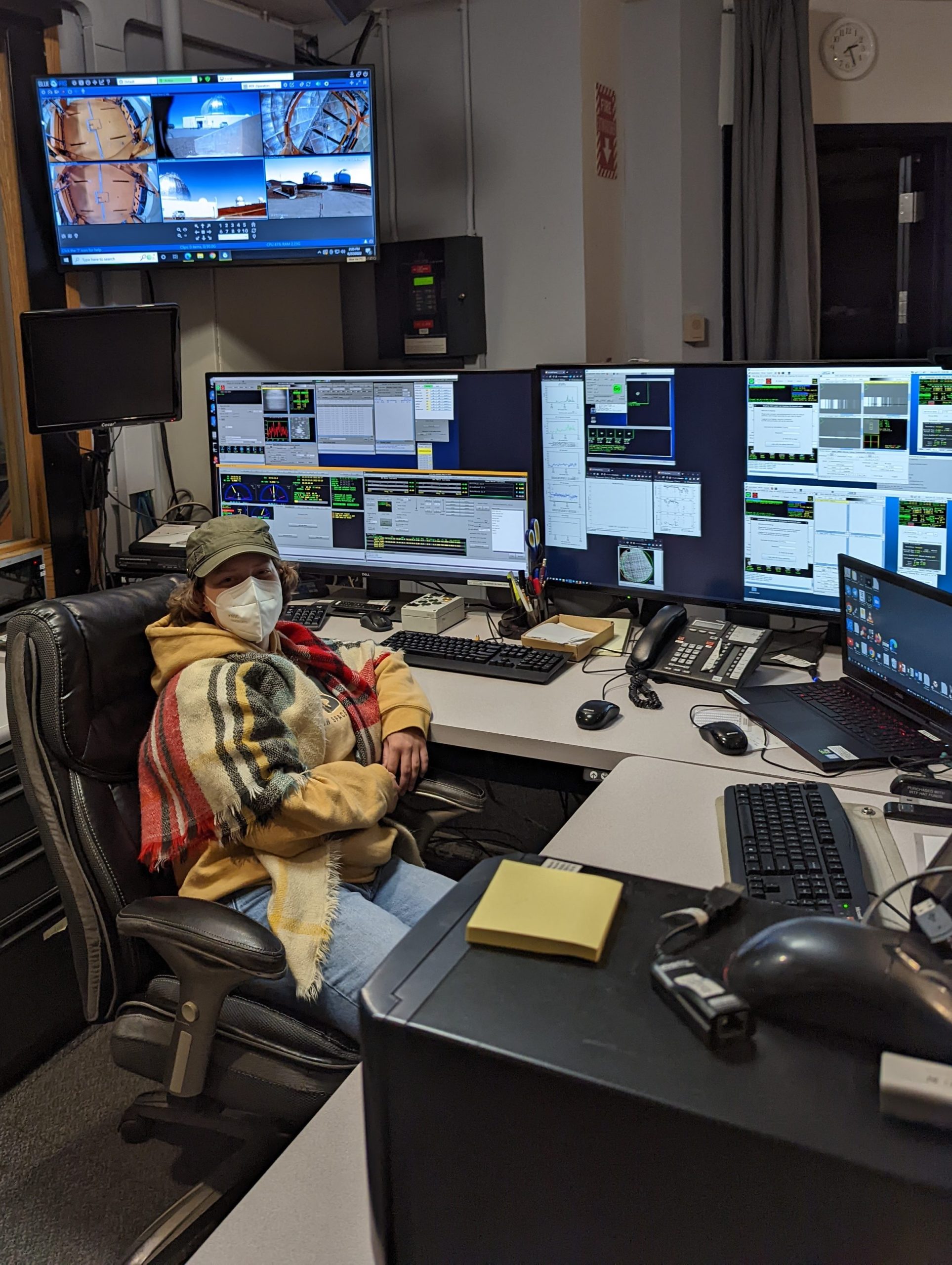 Thresa Kelly sits in a room surrounded by monitors