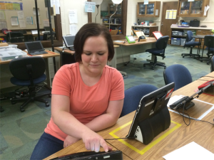 Amy in the Pardee Augmentative Alternative Communication lab (located at the Schiefelbusch Speech-Language-Hearing clinic) working on an AAC device