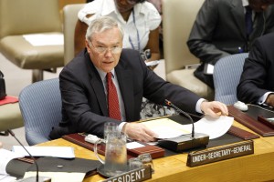 Lynn Pascoe an the United Nations with a placard that says 'Under-Secretary-General'