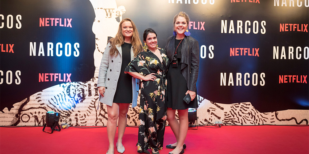 Sarah Stern and several others on the red carpet with a sign reading Netflix and Narcos