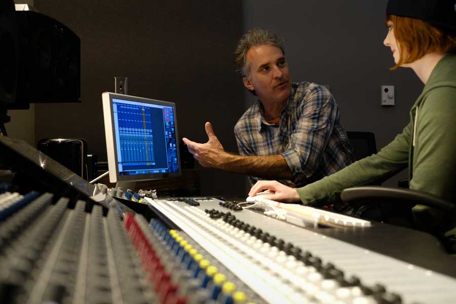 Robert Hurst, left, with a student in a Film and Media Studies Sound Design Class