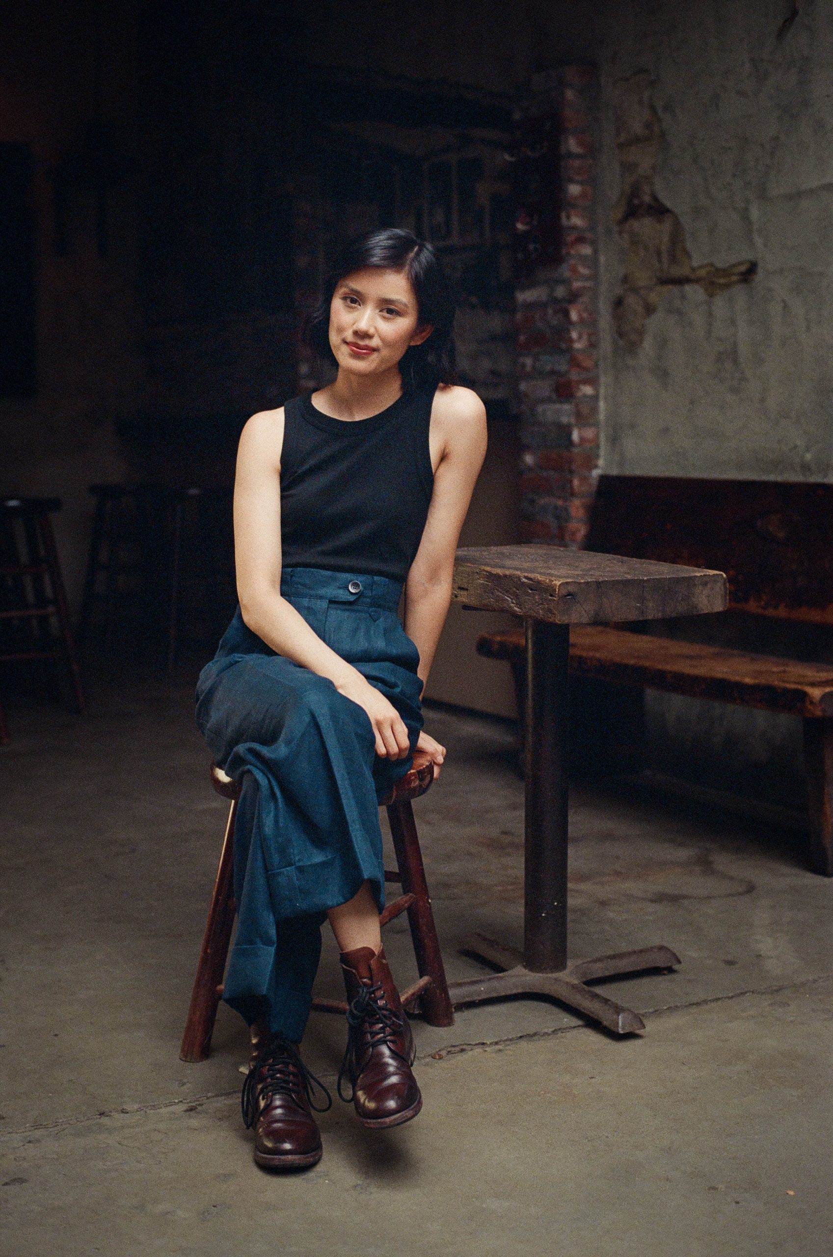 Tracey Lien sitting in a chair by a table