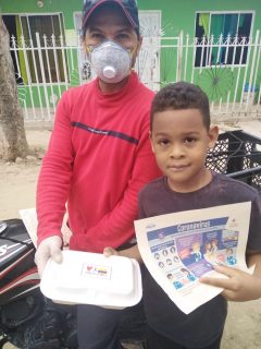 a man and child with a boxed meal