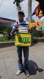 a man with a boxed meal giving a thumbs up