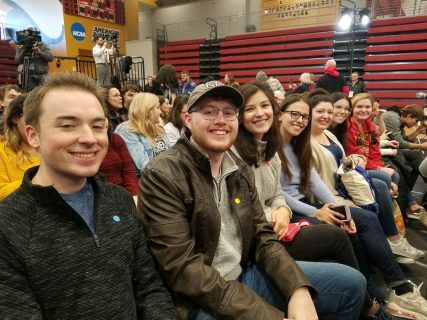 A row of people sitting in a gymnasium