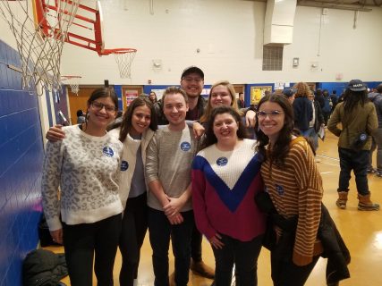 a group of people smiling in a gymnasium