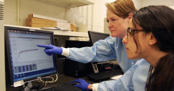 two people looking at results on a monitor