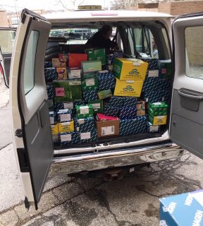 boxes of testing supplies in the back of the van