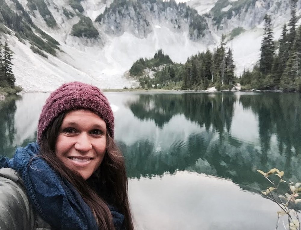 Becky Mandelbaum in front of a glacial lake