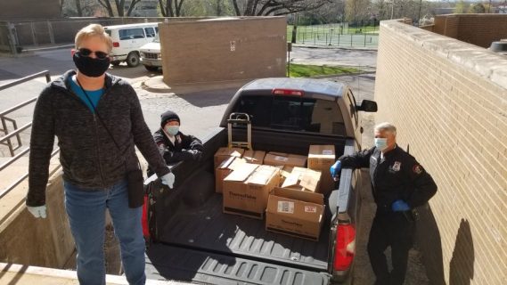 people unload supplies from the back of a truck