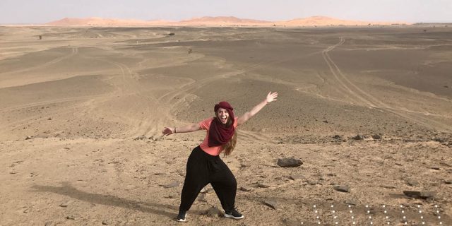 Lilah standing in a vast desert