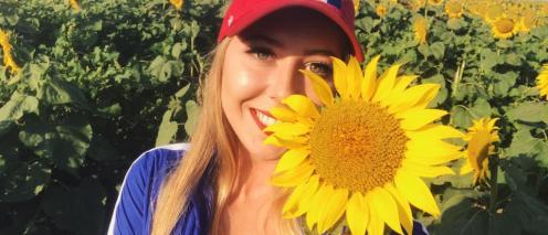 Tyan Fairbank holding a sunflower