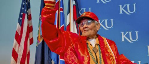 Chester Nez accepting his degree and waving to the crowd.