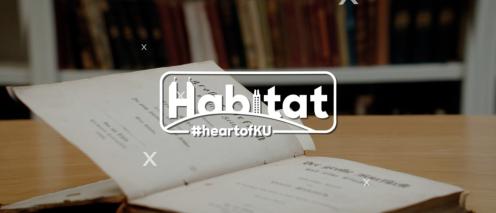 Habitat logo overlaying open book on table
