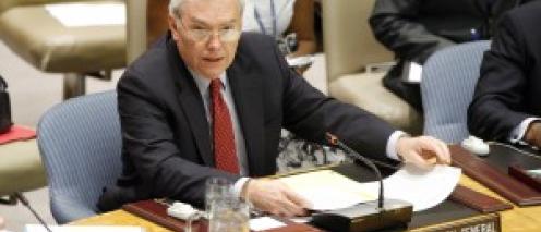 Lynn Pascoe an the United Nations with a placard that says 'Under-Secretary-General'