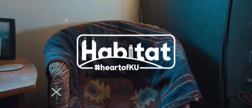 Habitat logo over blanket draped on a wicker chair
