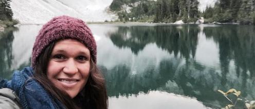 Becky Mandelbaum in front of a glacial lake