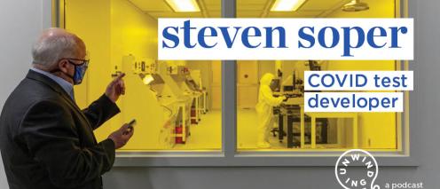 Steven Soper looking through glass into a clean room with the text 'COVID test developer'